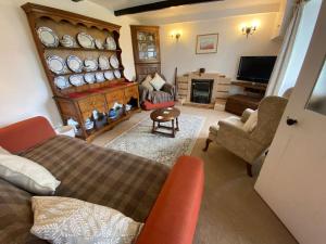 a living room with a bed and a tv at Scenic Welsh Cottage in the Brecon Beacons in Crickhowell
