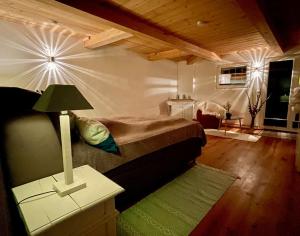 a bedroom with a bed and a table with a lamp at Ferienwohnung mit Luxusbad, Terrasse Ostseenähe in Gremersdorf