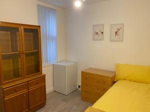 a bedroom with a bed and a dresser at Calm residential house in Wyken