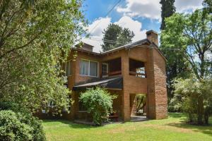 a brick house with trees in front of it at Parador 15 in Funes