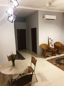 a living room with a table and chairs at Sarod Inn Meru Homestay 3-bedroom Apartment in Klang