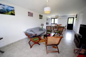 a living room with a couch and chairs at La Kaz à Léna La Plaine des Cafres in Le Tampon