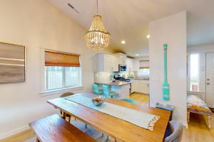 a kitchen and dining room with a wooden table at Turquoise Dreams in Lincoln City