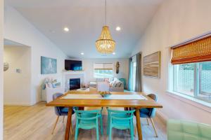 a dining room with a wooden table and blue chairs at Turquoise Dreams in Lincoln City