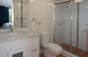 a bathroom with a toilet and a sink and a shower at Montana Palms Resort in Gold Coast