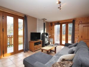 a living room with a couch and a tv at Chalet Mont-Dore, 4 pièces, 6 personnes - FR-1-608-10 in Le Mont-Dore