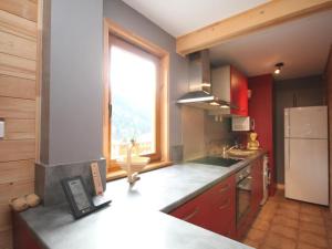 a kitchen with a counter and a large window at Chalet Mont-Dore, 4 pièces, 6 personnes - FR-1-608-10 in Le Mont-Dore