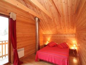 a log cabin with a bed in a room at Chalet Mont-Dore, 4 pièces, 6 personnes - FR-1-608-10 in Le Mont-Dore
