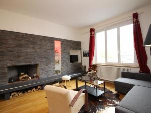 a living room with a brick fireplace and a couch at Appartement Mont-Dore, 3 pièces, 8 personnes - FR-1-608-1 in Le Mont-Dore