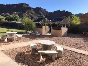 a group of picnic tables and a gazebo at BRISAS DEL VALLE San Rafael in Valle Grande