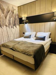 Un pat sau paturi într-o cameră la Jasna SportHotel & SPA