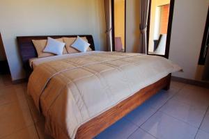 Postel nebo postele na pokoji v ubytování Ubud Canti Accommodation