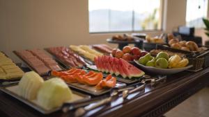 a buffet with different types of food on a table at Pousada Monttana in Lavras Novas