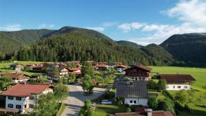 a village in a valley with mountains in the background at Haus Blindauer Eck in Reit im Winkl