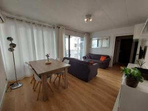 a living room with a table and a couch at Calafell Beach.Primera línea.Céntrico. in Calafell