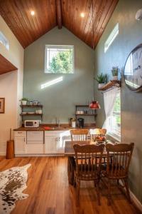 a kitchen with a table and chairs in a room at Cowbell Cabin 15min to Downtown Waco in Waco