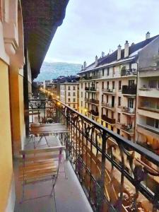 a balcony with two benches and a view of buildings at P&R 2, 2 bedroom, close to center, Plainpalais in Geneva