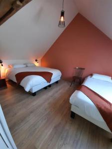 מיטה או מיטות בחדר ב-Le Fournil du Bertry