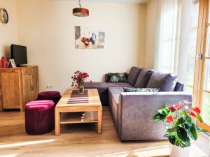 a living room with a couch and a table at Modern Mountain Apart 4 in Rauris