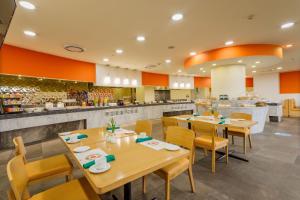 a restaurant with wooden tables and chairs and a counter at Camino Real Aeropuerto in Mexico City