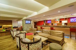 a hotel lobby with couches and a bar at Camino Real Aeropuerto in Mexico City