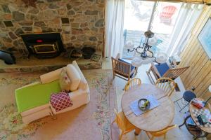 an aerial view of a living room with a table and a fireplace at Black River Cottage in Milford