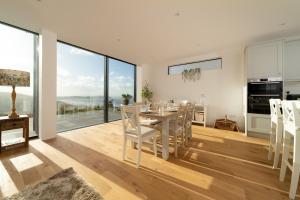 una cucina e una sala da pranzo con tavolo e sedie di Seymour Heights a Woolacombe Altre 20 foto