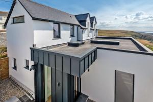 una vista esterna di una casa bianca con finestre nere di Seymour Heights a Woolacombe
