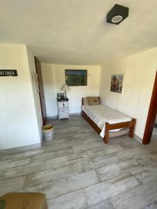 a bedroom with a bed and a tiled floor at Los Mirlos in La Cumbre