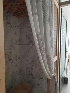 a room with a curtain on a wall at Aretousa Deluxe Downtown Apartment in Skala