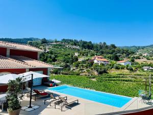 a villa with a swimming pool and a view at Solar Do Douro in Santa Cruz do Douro