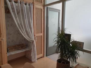 a room with a window and a door with a plant at Aretousa Deluxe Downtown Apartment in Skala