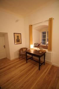 a living room with a table and a chair at Schloss Frauenthal in Deutschlandsberg