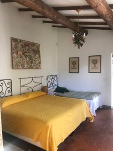 a bedroom with two beds and a ceiling at Il Pezzatino in Rufina