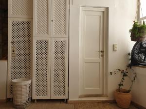 a room with a white cabinet and a door at Aretousa Deluxe Downtown Apartment in Skala