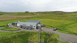 an aerial view of a house in a field at Salmon Landings in Strathy Point