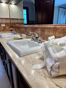 a bathroom counter with a sink and a mirror at Hotel Boutique Casa Veracruz in Estepona