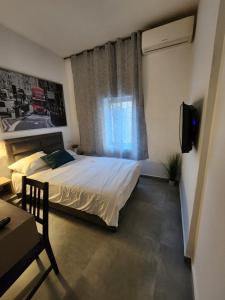 a small bedroom with a bed and a window at Ben Hillel Boutique Hotel in Jerusalem