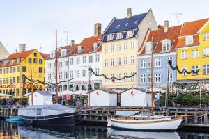 a group of boats docked in a harbor with buildings at New Harbor - Carolinas Apartment in Copenhagen