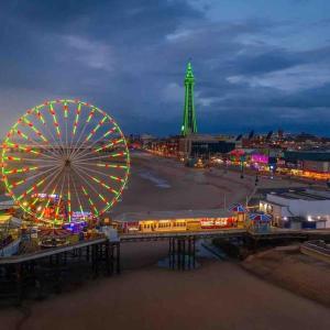 a ferris wheel and a roller coaster at a carnival at The BIG one! Large Holiday Home Blackpool. 3 floors of luxury. in Blackpool