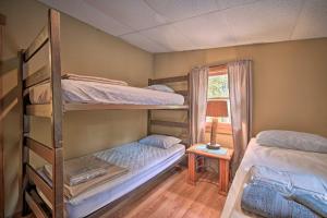 two bunk beds in a room with a window at James West Apt with 50 and Acres - Near Raystown Lake in Huntingdon