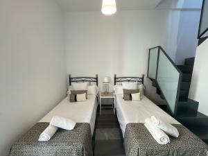 Posteľ alebo postele v izbe v ubytovaní DreamsApt Curtidores 6 Suites AT