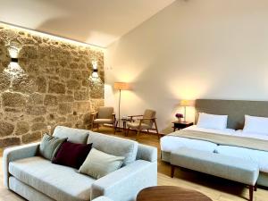 a hotel room with two beds and a couch at Quinta da Porta - Solar de Vale de Prazeres in Vale de Prazeres +94 photos