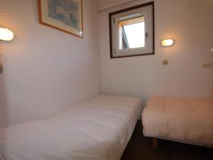 a small room with two beds and a window at Appartement Avoriaz, 3 pièces, 6 personnes - FR-1-633-31 in Avoriaz