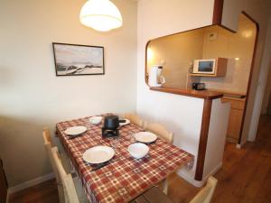 a dining room table with a red and white table cloth at Appartement Avoriaz, 2 pièces, 5 personnes - FR-1-633-23 in Avoriaz