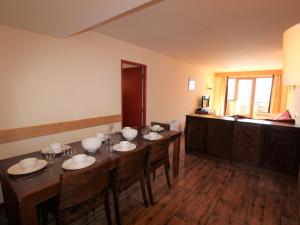 a dining room with a table and chairs and a kitchen at Appartement Avoriaz, 4 pièces, 8 personnes - FR-1-633-43 in Morzine