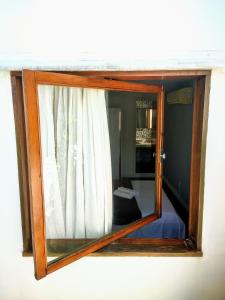 a window with a wooden frame on a wall at Luna Rossa Guest House in Rio de Janeiro