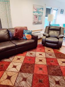 a living room with a couch and a chair at Hillcrest Inn in Seaside