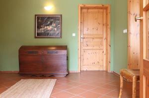 a room with a wooden dresser next to a door at Naturerlebnis in Malchin