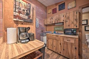 a kitchen with wooden cabinets and a counter with a microwave at Bill Pickett Apt on 50-Acre Ranch - 1 Mi to Lake in Huntingdon